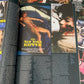 Book or magazine with text and images on a collage of movie posters.